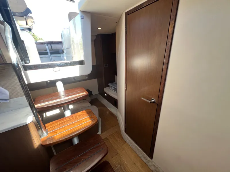Slide: The Image of Interior of 2018 Sea Ray Sundancer 350 Coupe with wooden stairs. - 35