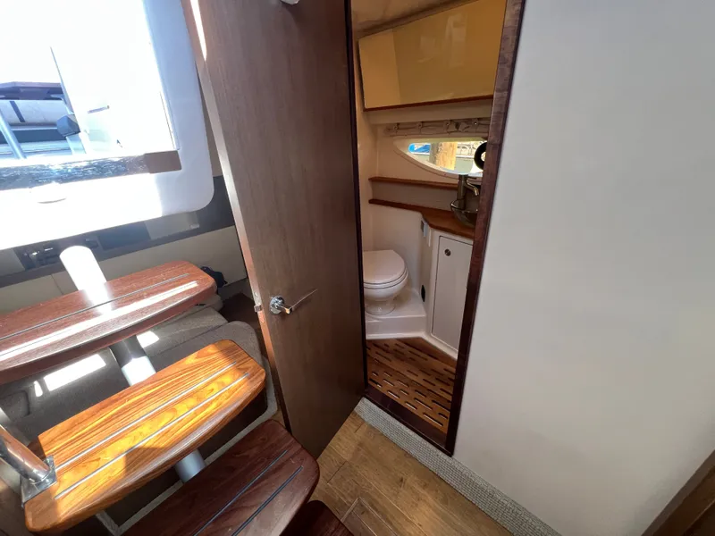 Slide: The Image of Interior of 2018 Sea Ray Sundancer 350 Coupe with bathroom and wooden stairs. - 36