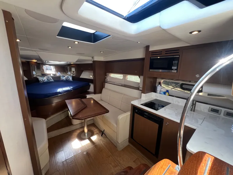 Slide: The Image of Interior of 2018 Sea Ray Sundancer 350 Coupe with kitchen and sleeping area. - 45