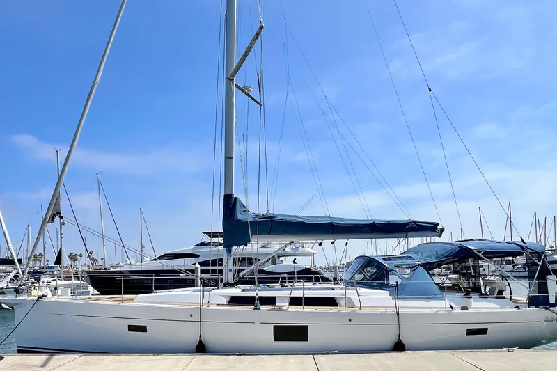 The Image of 2016 Hanse 455 sailboat docked at a marina under a clear blue sky. - 0