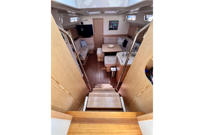 Slide: The Image of Interior of 2016 Hanse 455 yacht, featuring cozy seating, wooden flooring, and modern amenities. - 101