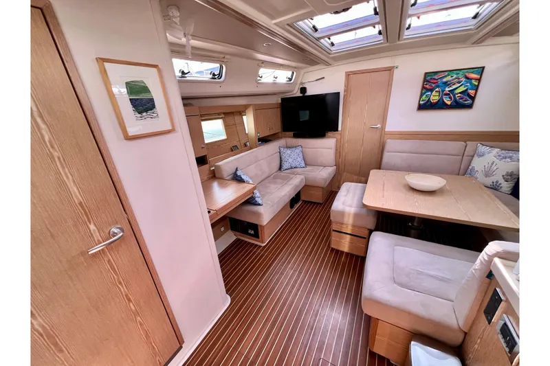Slide: The Image of Interior of 2016 Hanse 455 yacht with cozy seating, wooden flooring, and modern decor. - 102