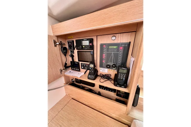 Slide: The Image of Control panel of a 2016 Hanse 455 yacht, featuring navigation and communication equipment. - 106