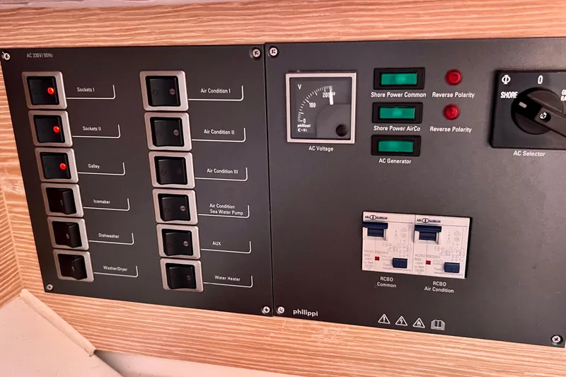 Slide: The Image of Electrical control panel on a 2016 Hanse 455 yacht, featuring switches and voltage indicators. - 116