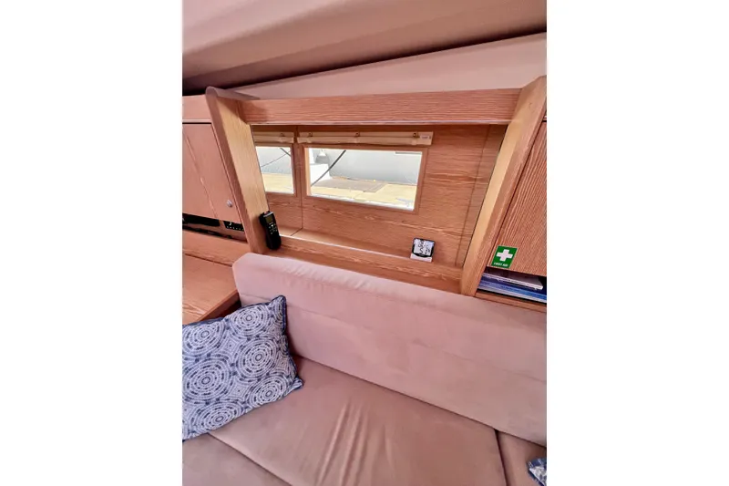 Slide: The Image of Interior of 2016 Hanse 455 yacht with wooden paneling and cozy seating area. - 117