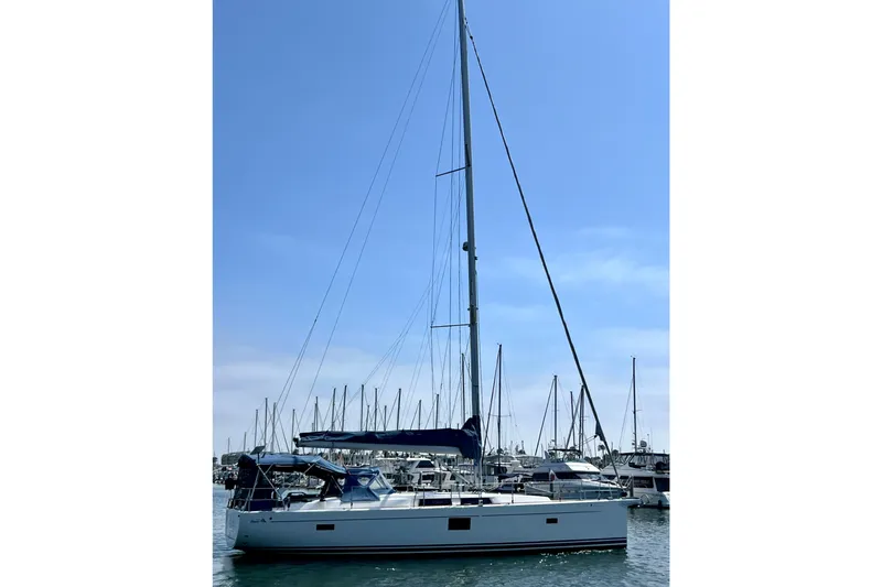 Slide: The Image of 2016 Hanse 455 sailboat docked in a marina under a clear blue sky. - 12