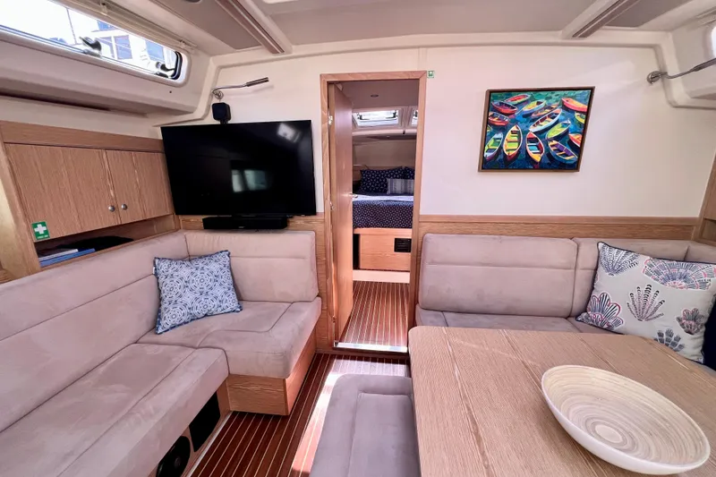 Slide: The Image of Interior of 2016 Hanse 455 yacht with cozy seating, TV, and colorful artwork. - 122