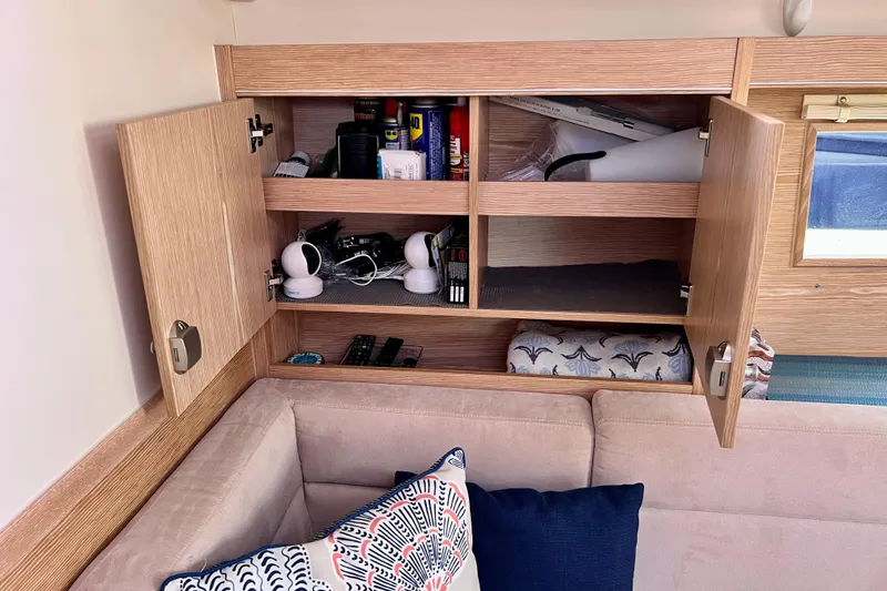 Slide: The Image of Interior of 2016 Hanse 455 yacht with open wooden cabinets and cozy seating area. - 125