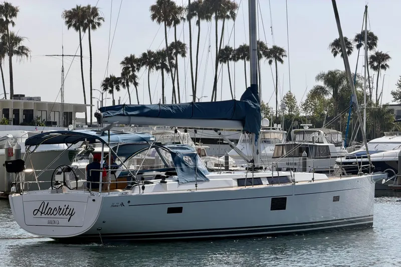 Slide: The Image of 2016 Hanse 455 sailboat docked in marina with palm trees in background. - 13
