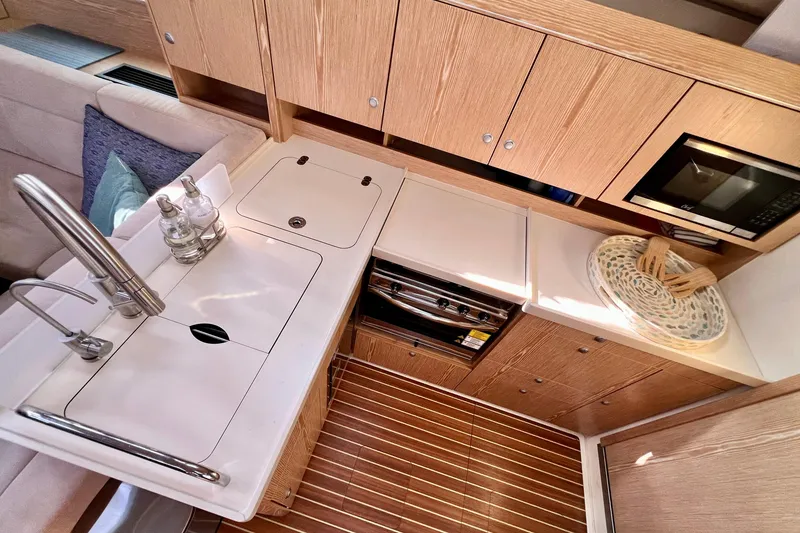 Slide: The Image of Modern kitchen interior of 2016 Hanse 455 yacht with wooden cabinetry and sleek appliances. - 134