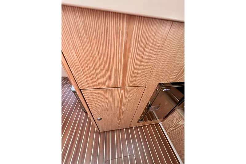 Slide: The Image of Wooden interior of 2016 Hanse 455 yacht, featuring sleek cabinetry and striped flooring. - 136