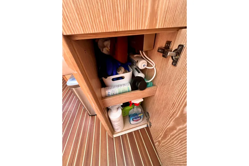 Slide: The Image of Cabinet storage on 2016 Hanse 455 yacht with cleaning supplies and toiletries. - 137
