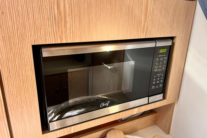 Slide: The Image of Built-in microwave in a 2016 Hanse 455 yacht kitchen, featuring a sleek stainless steel design. - 140