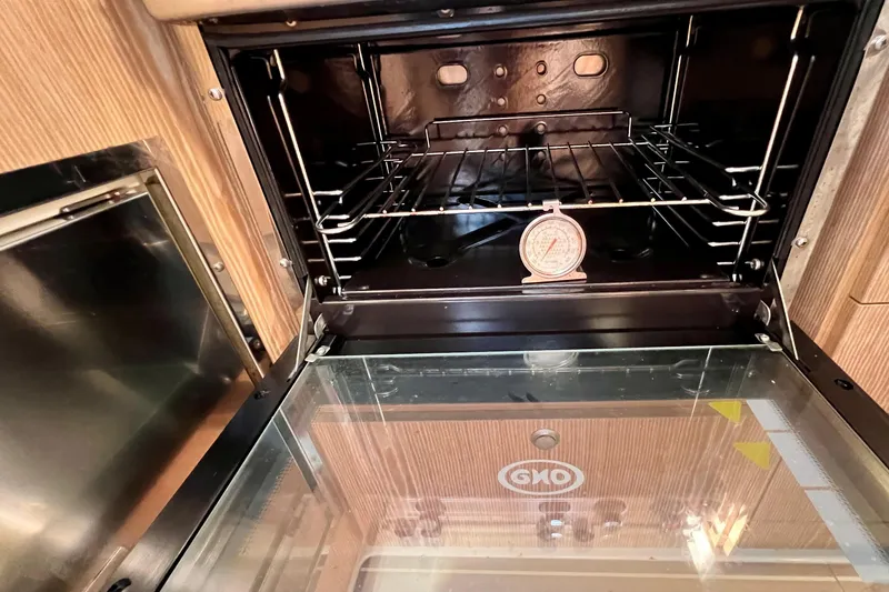 Slide: The Image of Open oven with thermometer inside, aboard a 2016 Hanse 455 yacht. - 144
