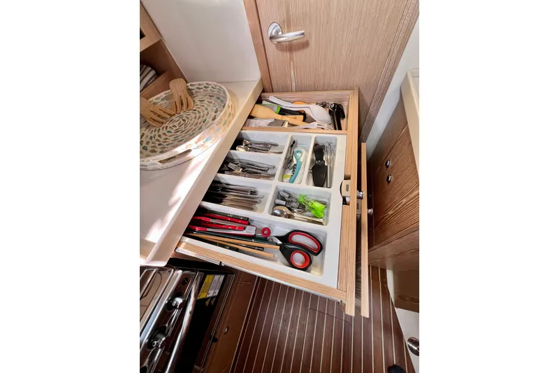 Slide: The Image of Open drawer with organized utensils and tools on a 2016 Hanse 455 yacht. - 146