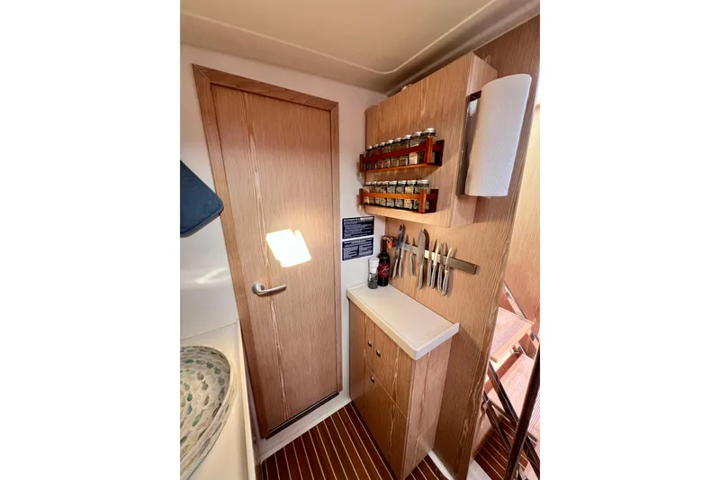 Slide: The Image of Compact kitchen area in a 2016 Hanse 455 yacht with spice rack and knife holder. - 147