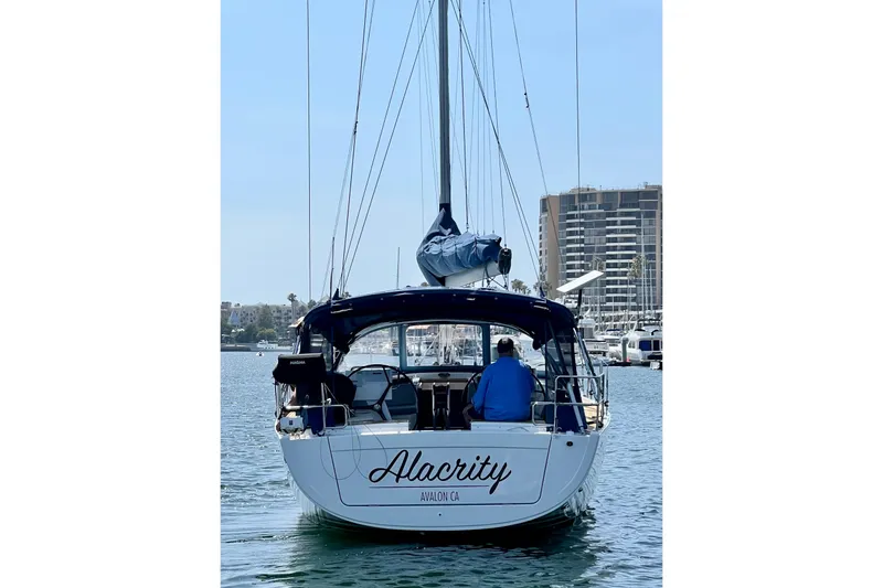 Slide: The Image of Sailboat Hanse 455 (2016) named Alacrity in marina, cityscape background. - 15