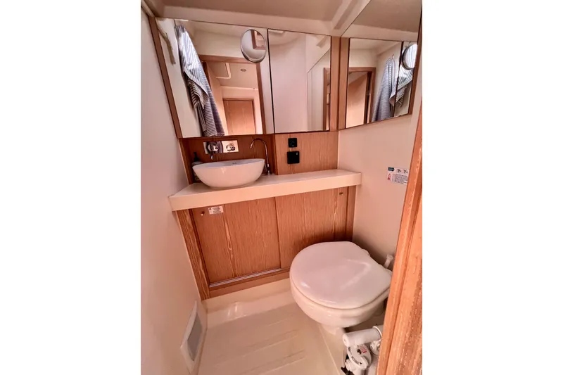 Slide: The Image of Compact bathroom in 2016 Hanse 455 yacht with sink, mirror, and toilet. - 161