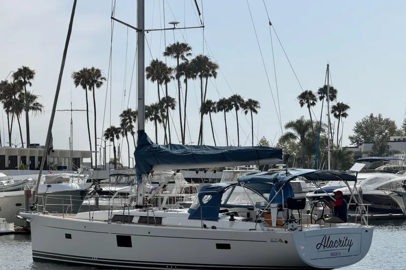 Slide: The Image of 2016 Hanse 455 sailboat docked in marina with palm trees in background. - 17