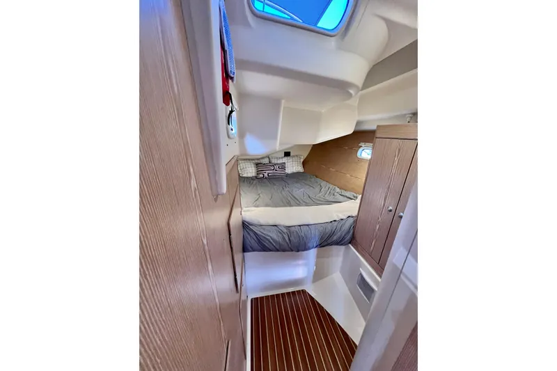 Slide: The Image of Cozy cabin interior of 2016 Hanse 455 yacht with bed and wooden cabinetry. - 170