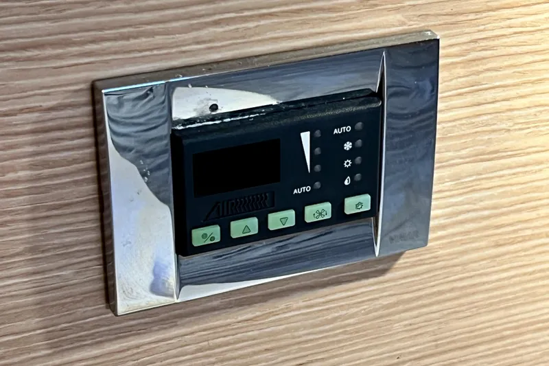 Slide: The Image of Digital control panel on a 2016 Hanse 455 yacht, mounted on wooden interior. - 172
