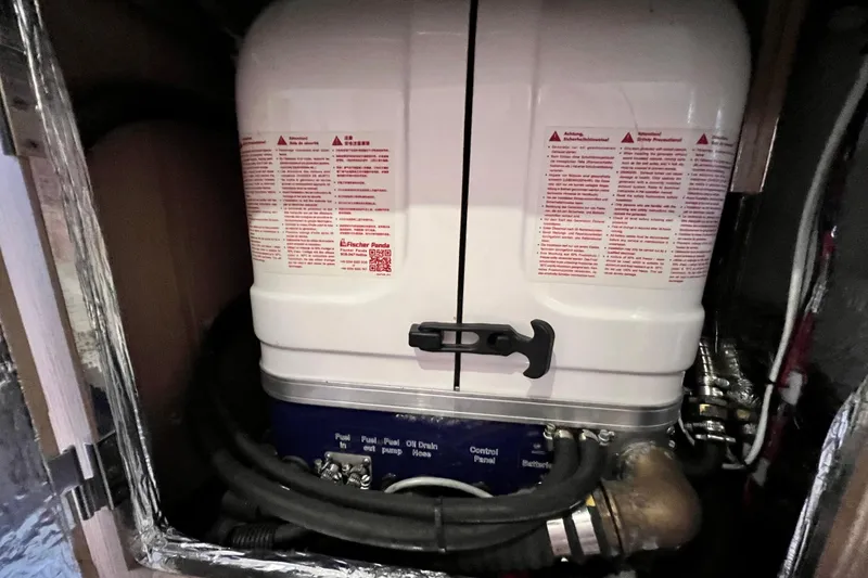 Slide: The Image of Engine compartment of a 2016 Hanse 455 yacht, featuring a Fischer Panda generator. - 176