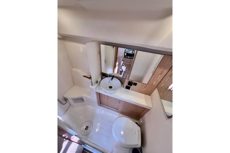 Slide: The Image of Bathroom interior of 2016 Hanse 455 yacht, featuring sink, mirror, and toilet. - 179