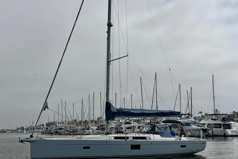 Slide: The Image of 2016 Hanse 455 sailboat docked in a marina, surrounded by other boats. - 18