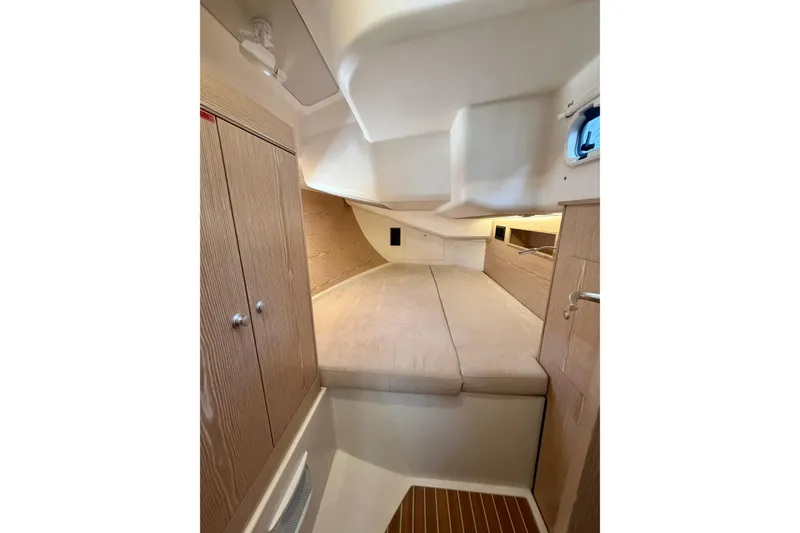 Slide: The Image of Interior cabin of 2016 Hanse 455 yacht with cozy bed and wooden cabinetry. - 182
