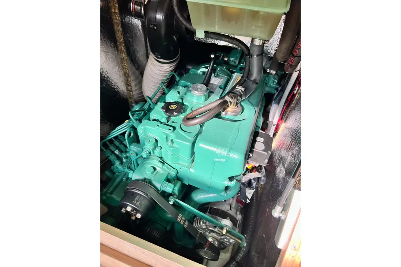 Slide: The Image of Engine compartment of a 2016 Hanse 455 yacht, showcasing a green marine engine. - 184