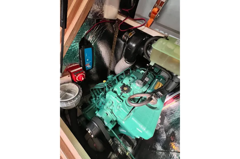 Slide: The Image of Engine compartment of a 2016 Hanse 455 yacht, featuring a green marine engine. - 185