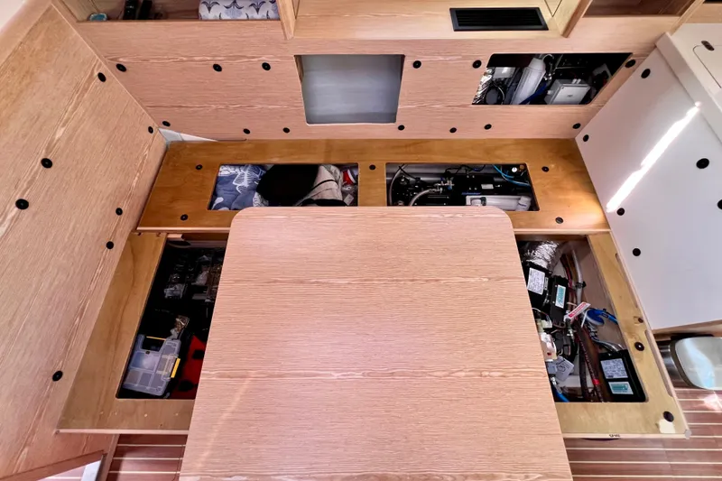 Slide: The Image of Interior view of a 2016 Hanse 455 yacht, showcasing under-seat storage compartments. - 186