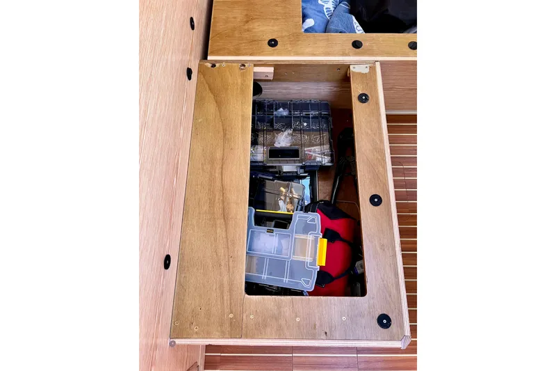 Slide: The Image of Storage compartment on a 2016 Hanse 455 yacht, containing various tools and equipment. - 187