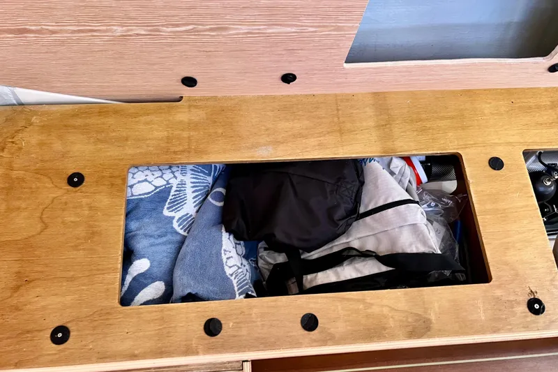Slide: The Image of Storage compartment on a 2016 Hanse 455 yacht, containing towels and gear. - 188