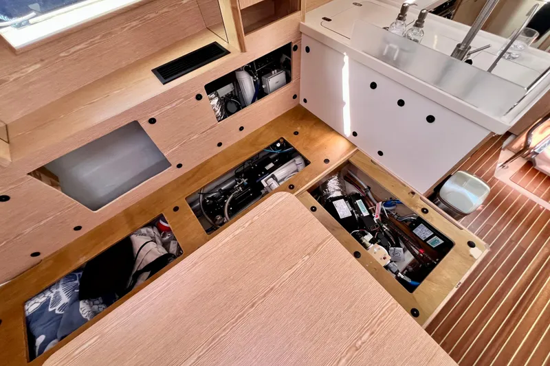 Slide: The Image of Interior view of a 2016 Hanse 455 yacht, showcasing underfloor storage compartments. - 190
