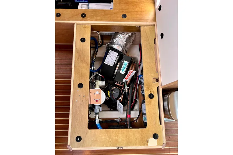 Slide: The Image of Engine compartment of a 2016 Hanse 455 yacht, showcasing mechanical components. - 191