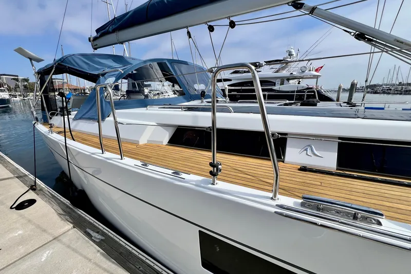 Slide: The Image of 2016 Hanse 455 yacht docked at marina, featuring sleek design and wooden deck. - 23