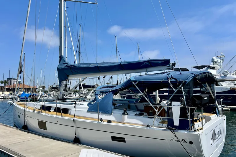 Slide: The Image of 2016 Hanse 455 sailboat docked at marina under clear blue sky. - 3