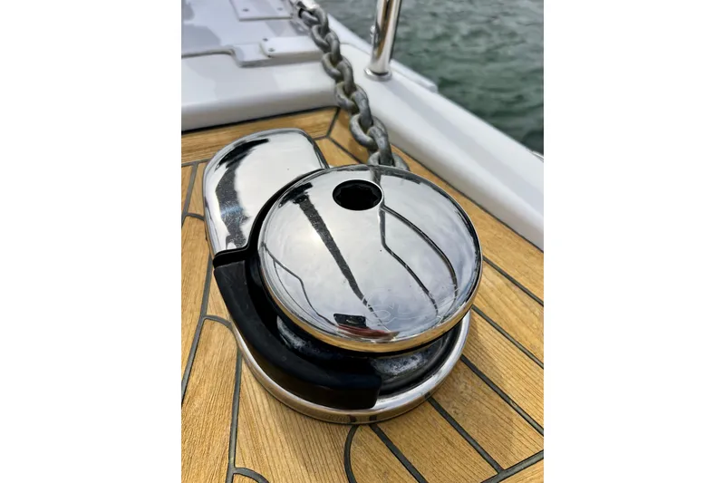 Slide: The Image of Chrome winch on 2016 Hanse 455 yacht deck with chain, near water. - 37
