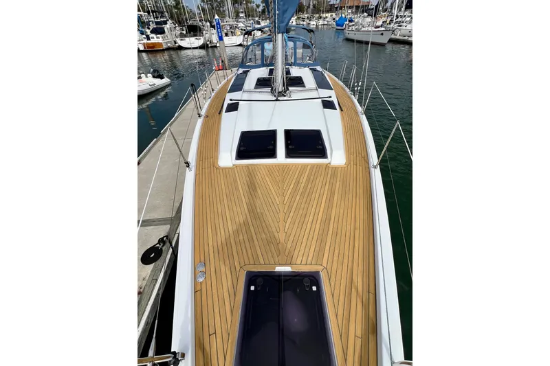 Slide: The Image of 2016 Hanse 455 yacht with teak deck, docked in a marina. - 38