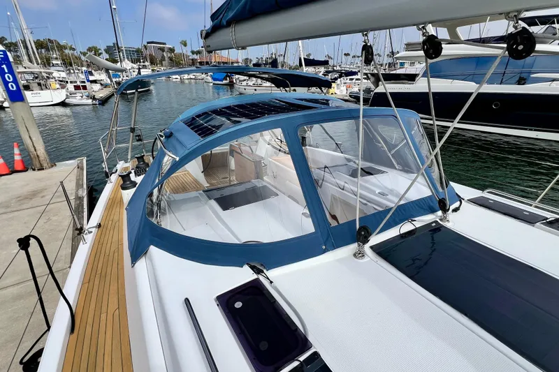 Slide: The Image of 2016 Hanse 455 sailboat docked at marina, featuring sleek design and blue canopy. - 41