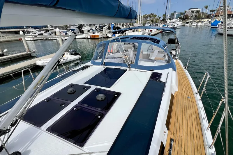 Slide: The Image of 2016 Hanse 455 yacht docked in marina, showcasing sleek design and spacious deck. - 44