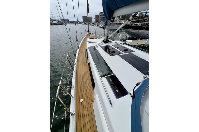 Slide: The Image of 2016 Hanse 455 sailboat deck with teak finish, docked in a marina. - 45