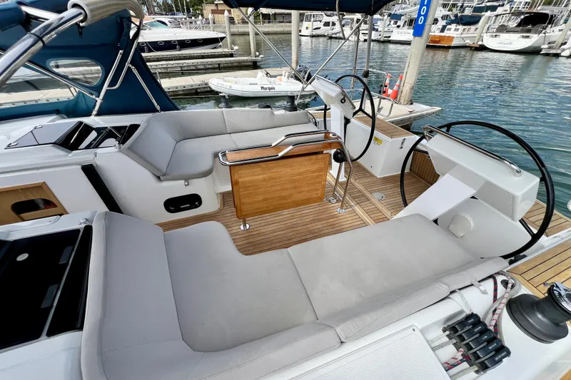 Slide: The Image of 2016 Hanse 455 yacht cockpit with dual steering wheels and comfortable seating at marina. - 51