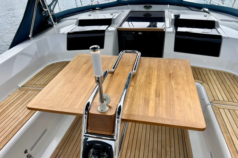 Slide: The Image of Cockpit of 2016 Hanse 455 yacht with wooden table and sleek design. - 57