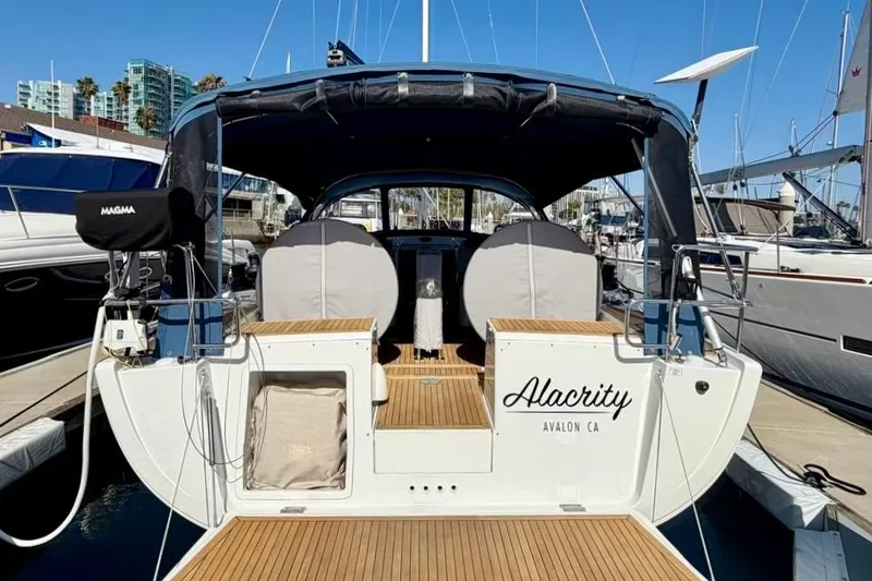 Slide: The Image of 2016 Hanse 455 sailboat docked, featuring a spacious cockpit and elegant design. - 6