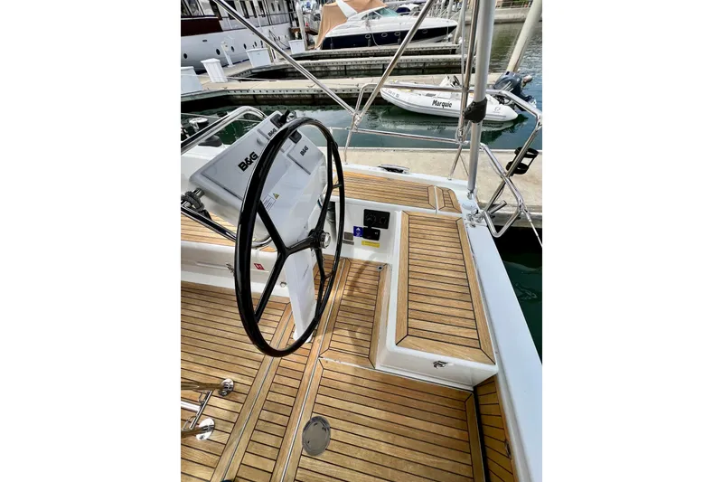 Slide: The Image of Cockpit of 2016 Hanse 455 yacht with wooden deck and steering wheel. - 60