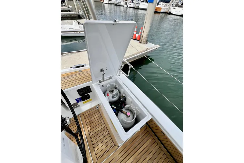 Slide: The Image of Open storage compartment on 2016 Hanse 455 yacht, revealing gas cylinders on deck. - 61