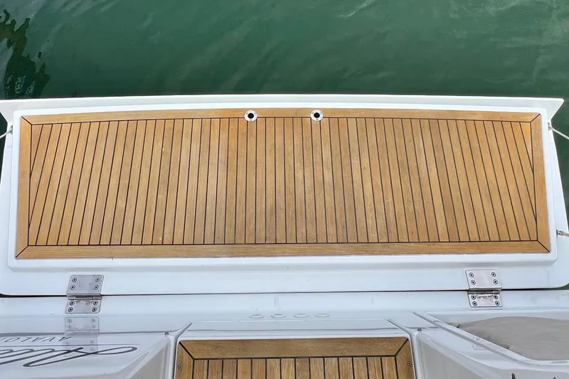 Slide: The Image of Teak deck of 2016 Hanse 455 yacht, featuring sleek wood paneling and stainless steel fittings. - 64