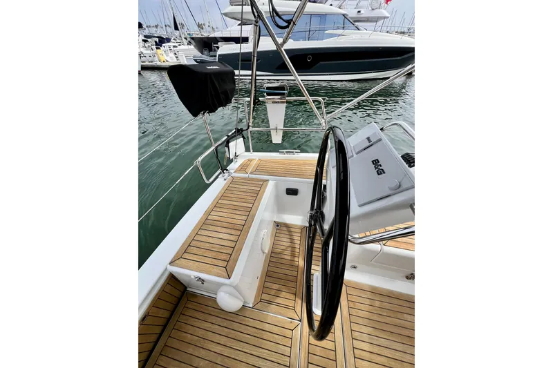 Slide: The Image of Cockpit of 2016 Hanse 455 yacht with teak flooring and steering wheel, docked at marina. - 67